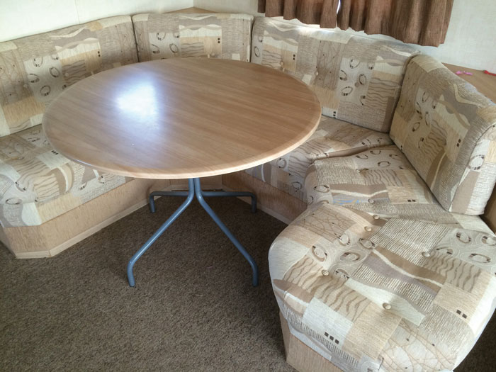 A shaped static caravan dining area seating unit re-upholstered in a contemporary patterned fabric