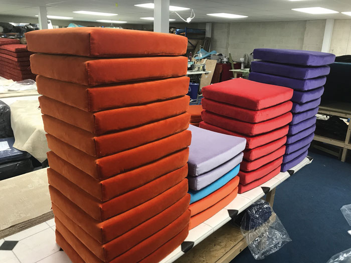 Newly upholstered seat cushions ready to be packed and despatched